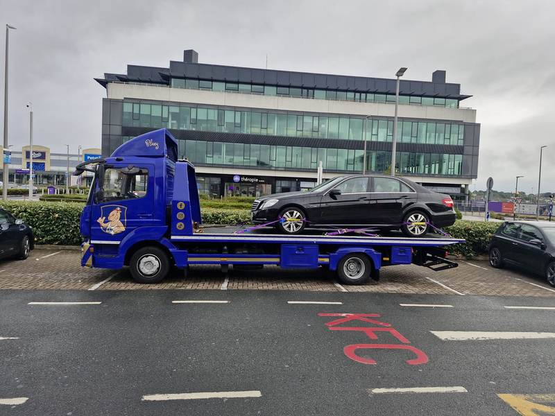 Black Mercedes loaded on Camel Tow truck “Bluey” in a Dublin retail park